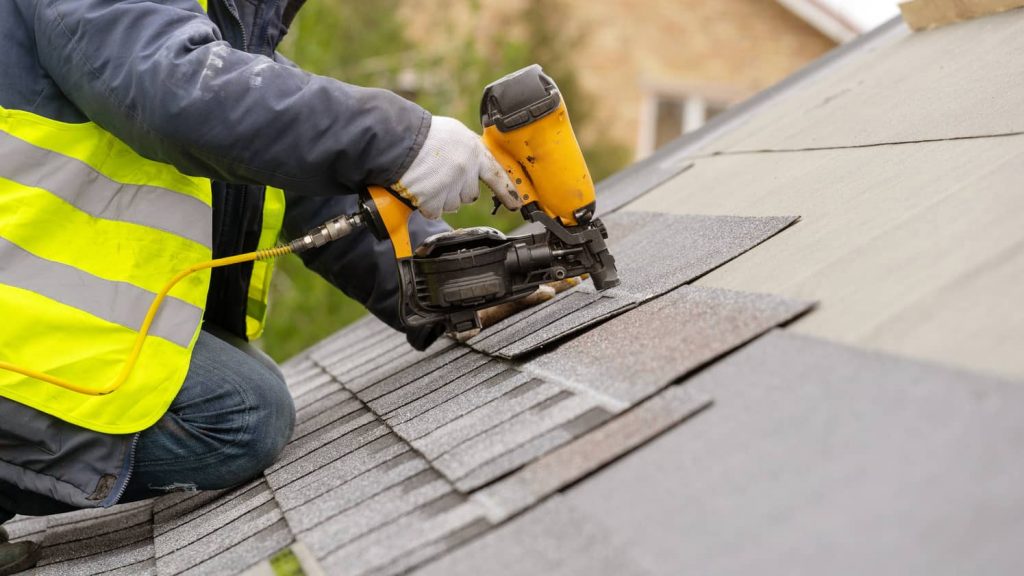 Installing a new composition roof.