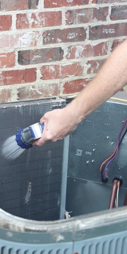 Cleaning the coils of the outdoor ac unit.