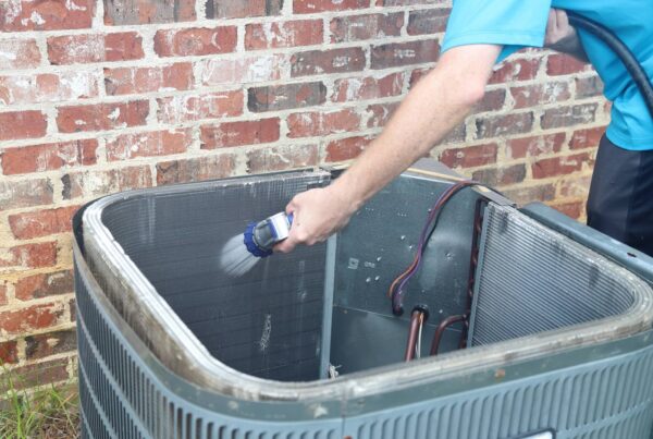 Cleaning the coils of the outdoor ac unit.