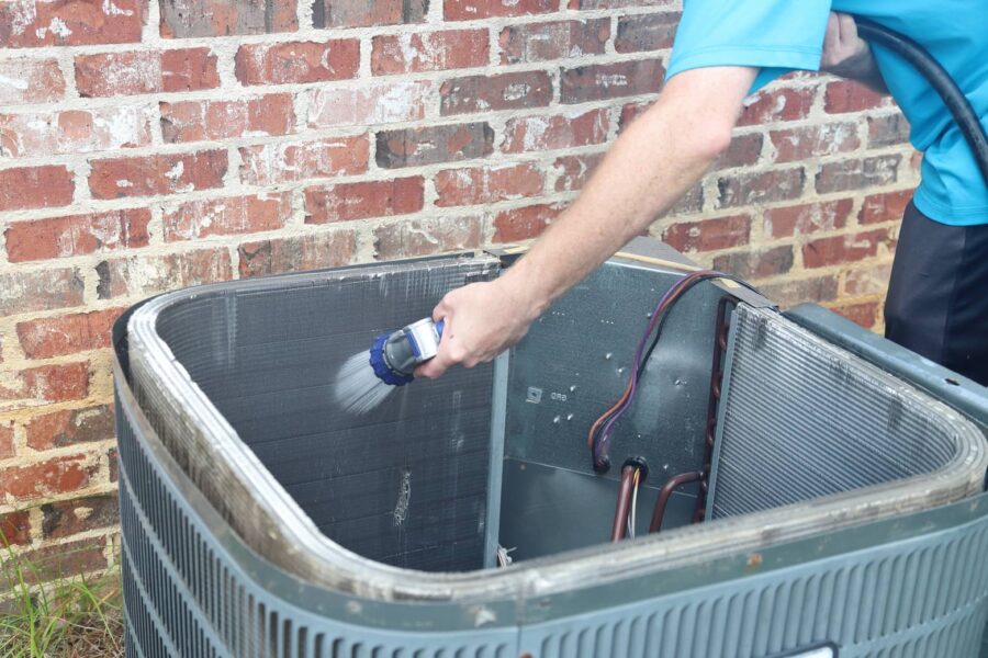 Cleaning the coils of the outdoor ac unit.