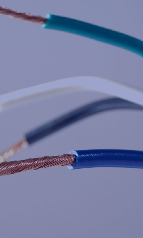 A close-up of multiple colored electrical wires with stripped insulation and exposed copper strands.