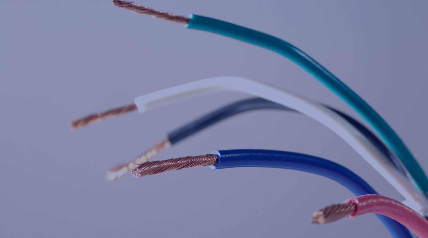 A close-up of multiple colored electrical wires with stripped insulation and exposed copper strands.